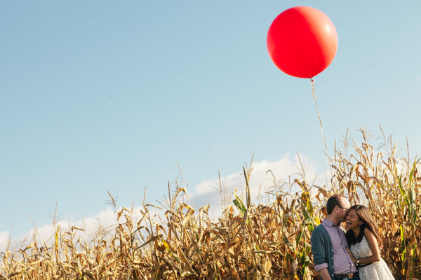 Whimsical balloon in a field for engagement photos. www.rebeccachan.ca